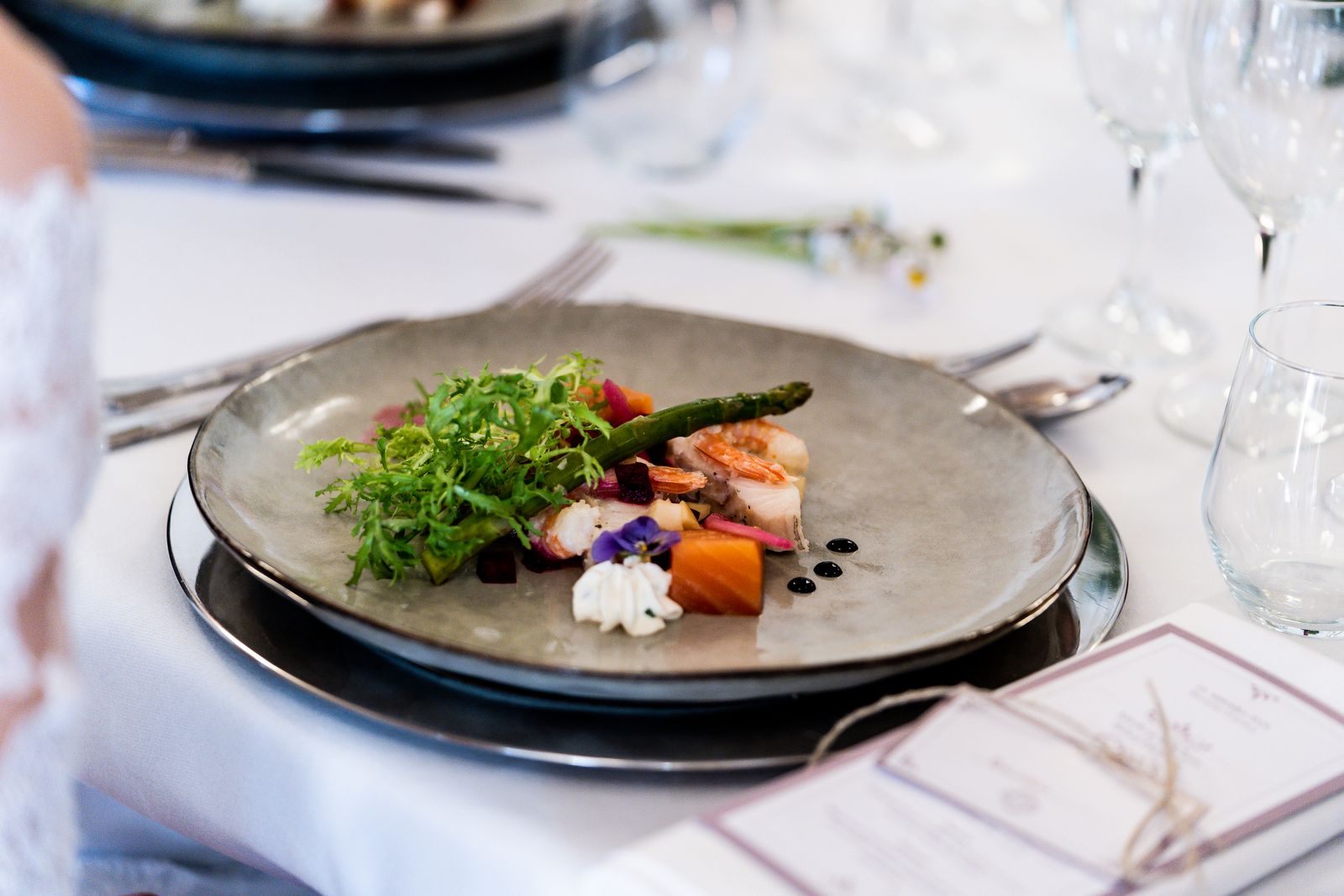 Plated gourmet dish on a set dining table, served by the staff that gratuities support on a free gratuities cruise